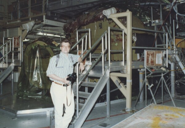 Jim Plaxco in front of space shuttle Endeavour under construction